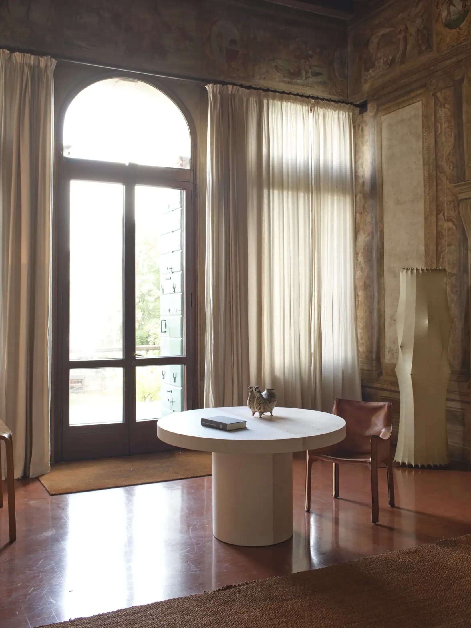 Sculptural round Cimento table in a historic interior